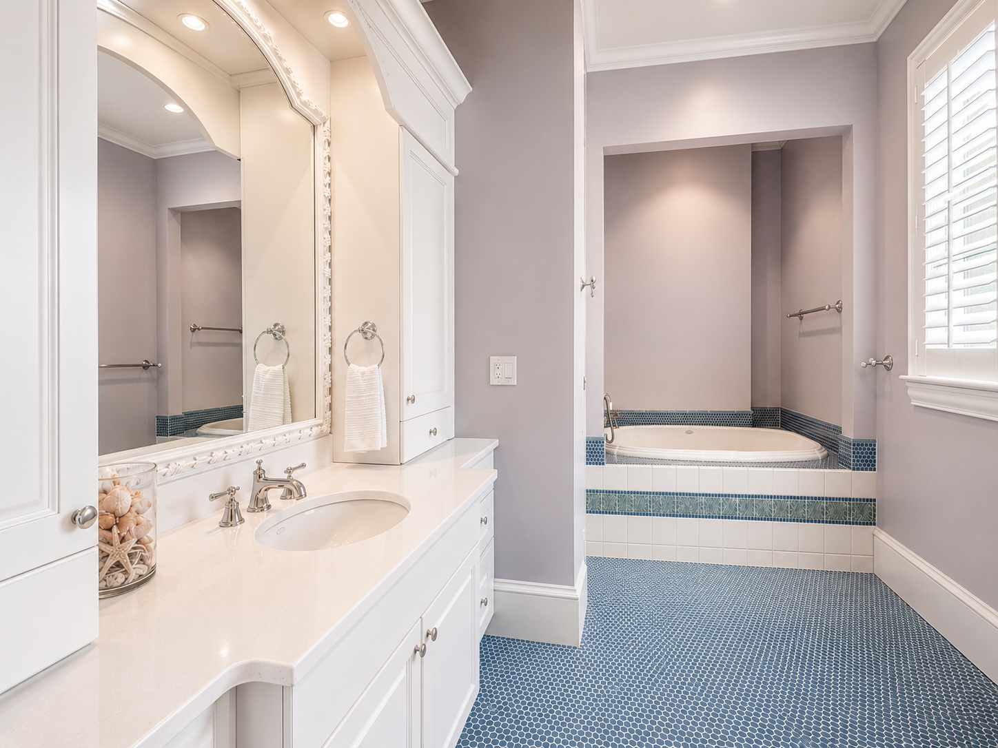 Secondary bath with freestanding soaking tub and mosaic marble floor