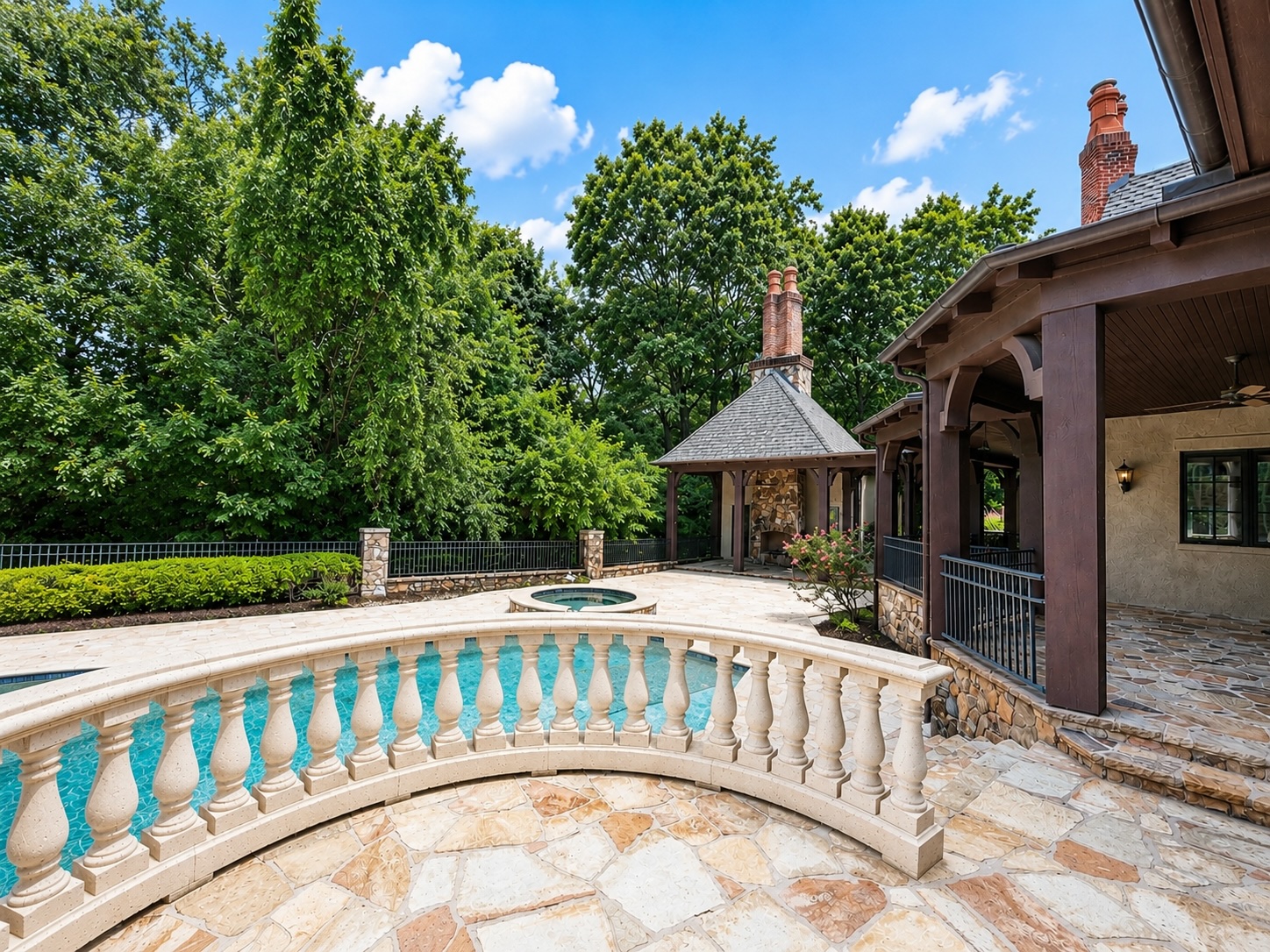 Resort backyard with pool, spa, stone balustrade, and covered pavilion overlooking Ironhorse Golf Course