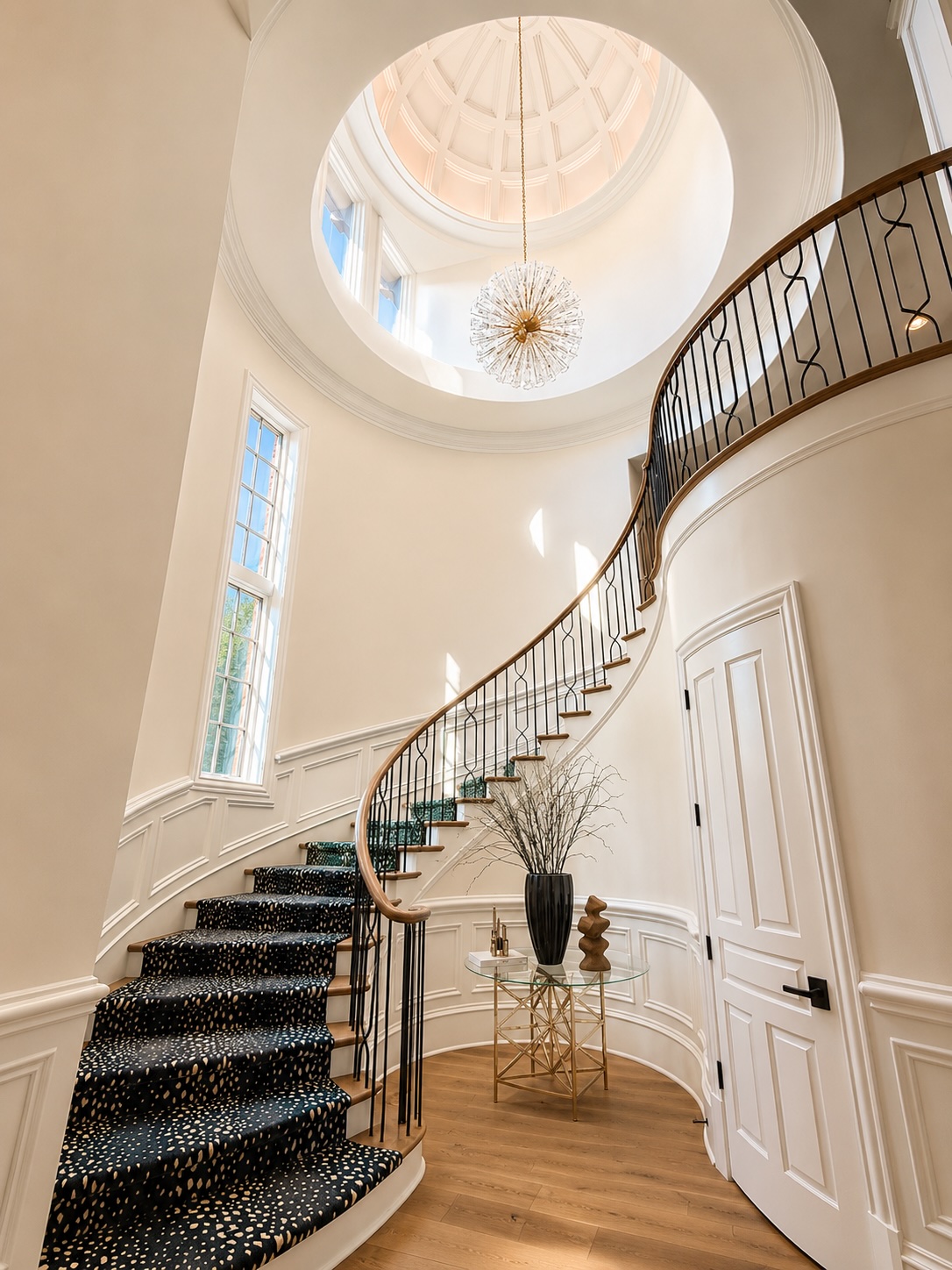 Two-story foyer with curved staircase beneath a domed ceiling at 8600 Longview Club Drive