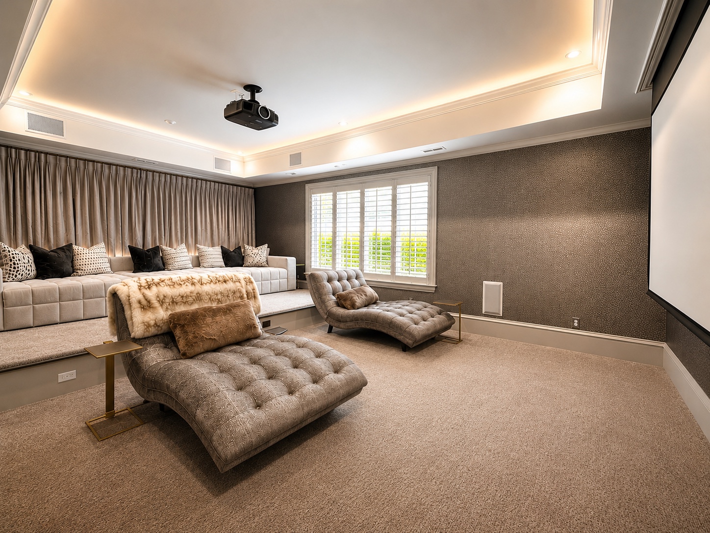 Home theater with tiered lounge seating and large projection screen