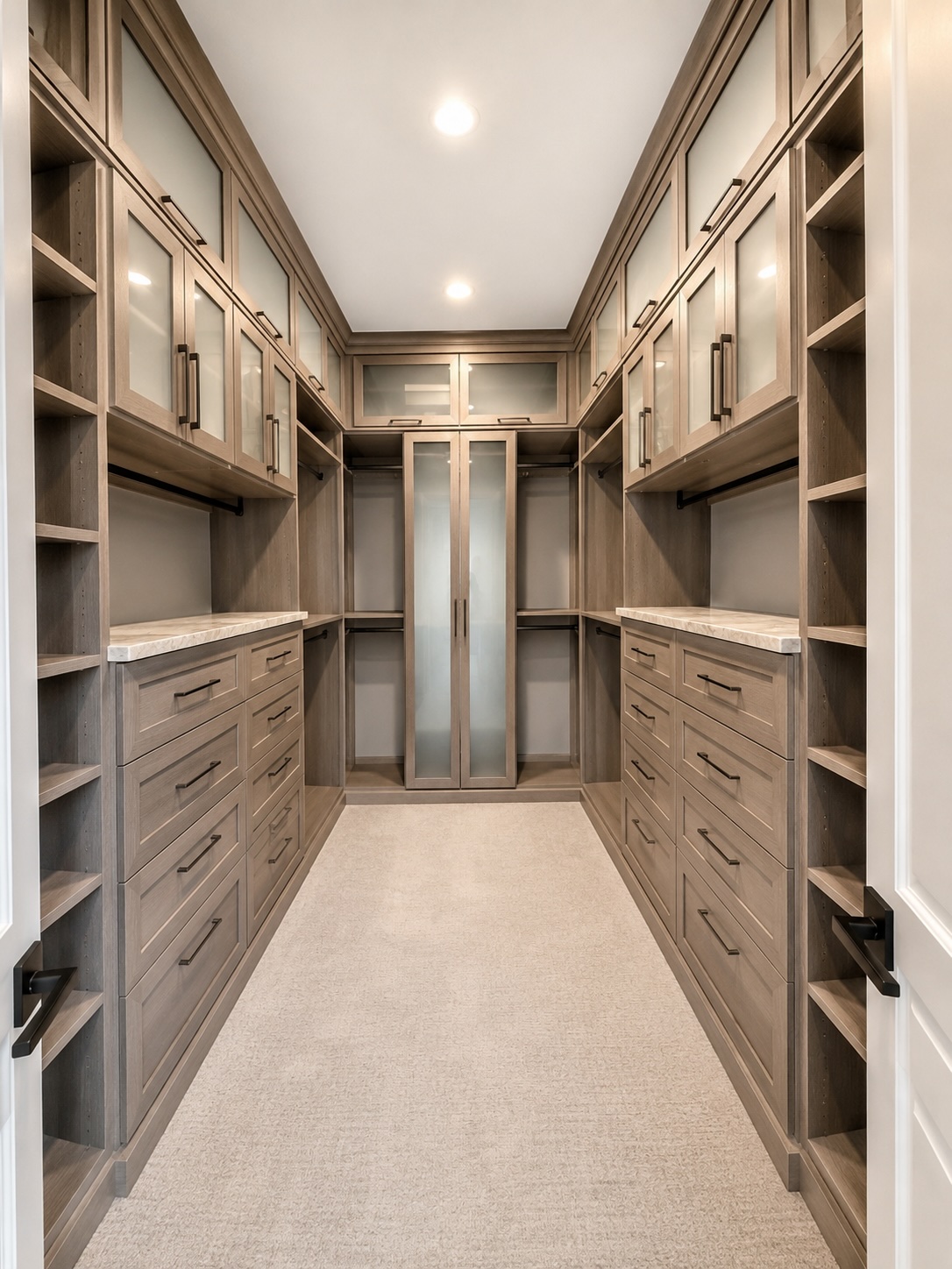 His walk-in dressing room with paneled cabinetry and built-in valet