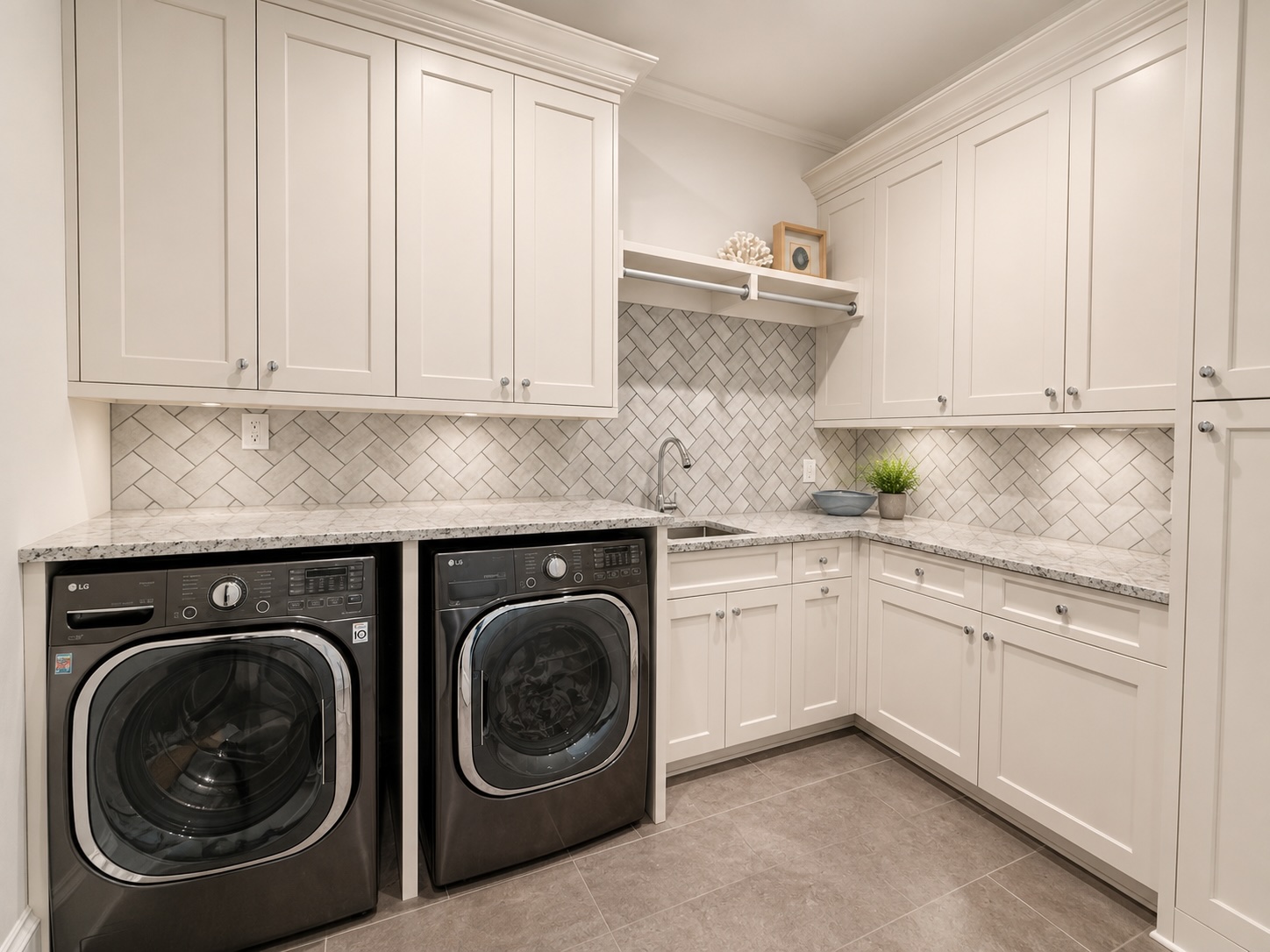 Upstairs laundry room with herringbone tile and dual LG washers and dryers