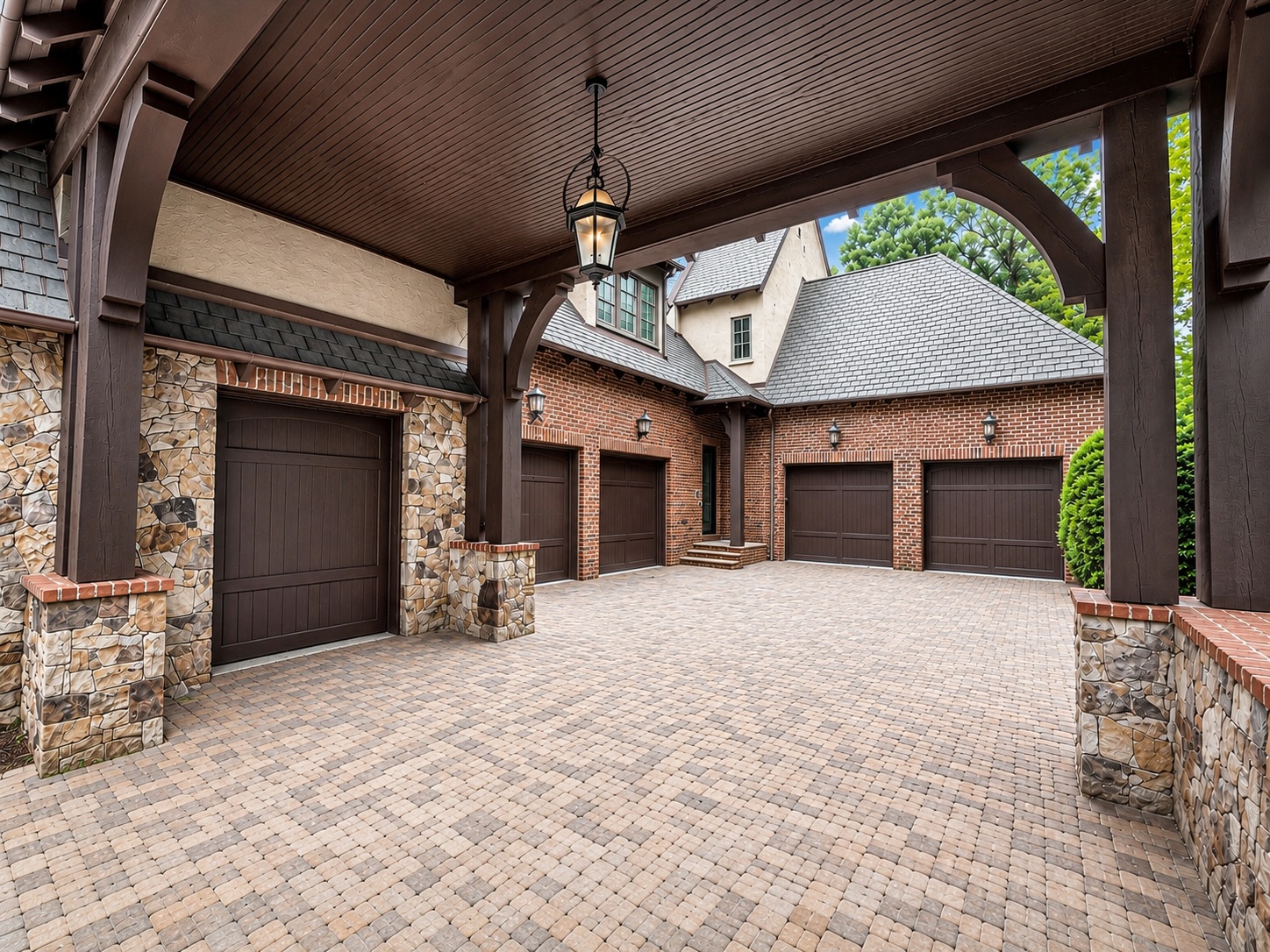 Porte-cochère with timber trusses leading to the multi-car garage court