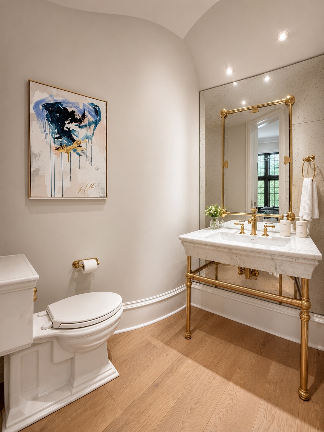 Powder room with brass console vanity, vaulted ceiling, and hand-painted wallpaper