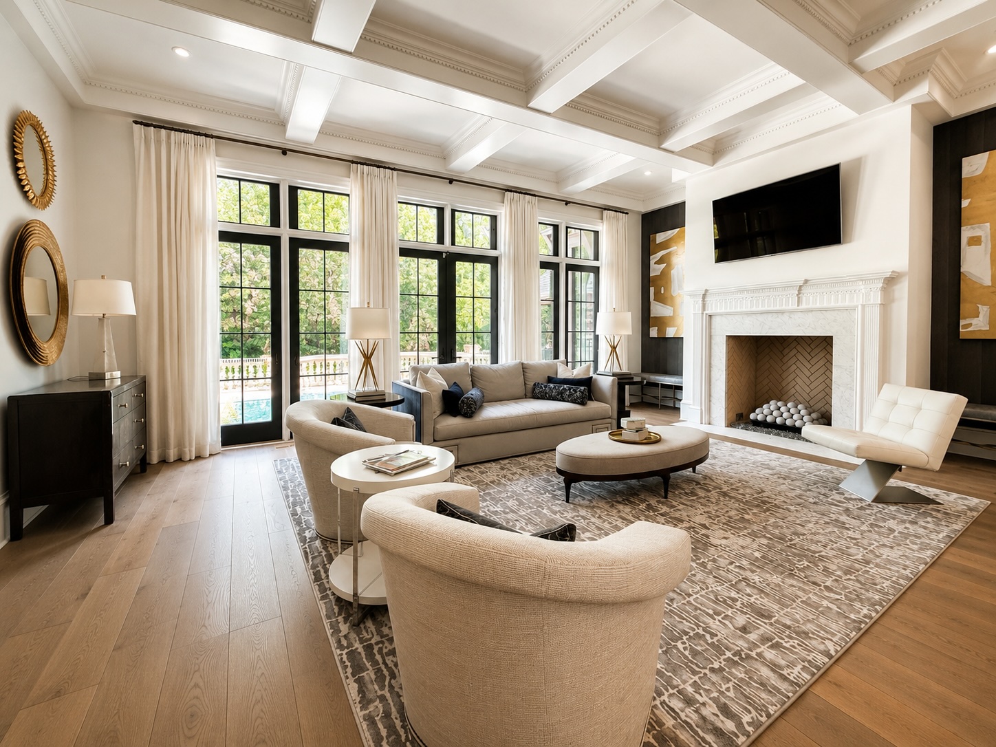Living room with marble fireplace, custom built-ins, and views of the pool and golf course