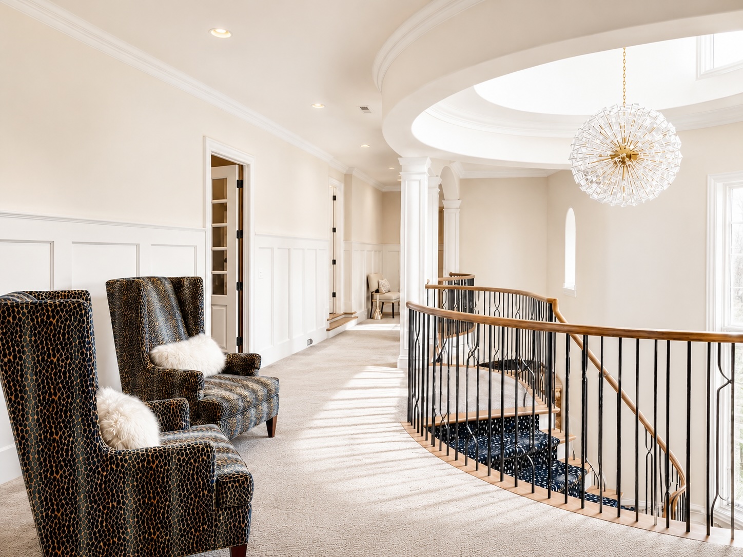 Upstairs loft with rotunda ceiling, curved balustrade, and chandelier